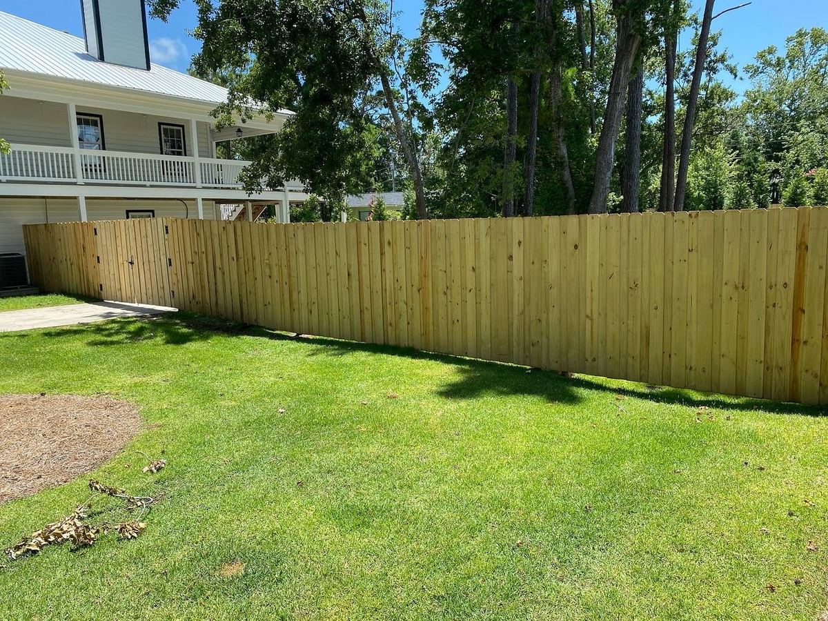 Freshly built wood privacy fence with gate by NSEA Restoration
