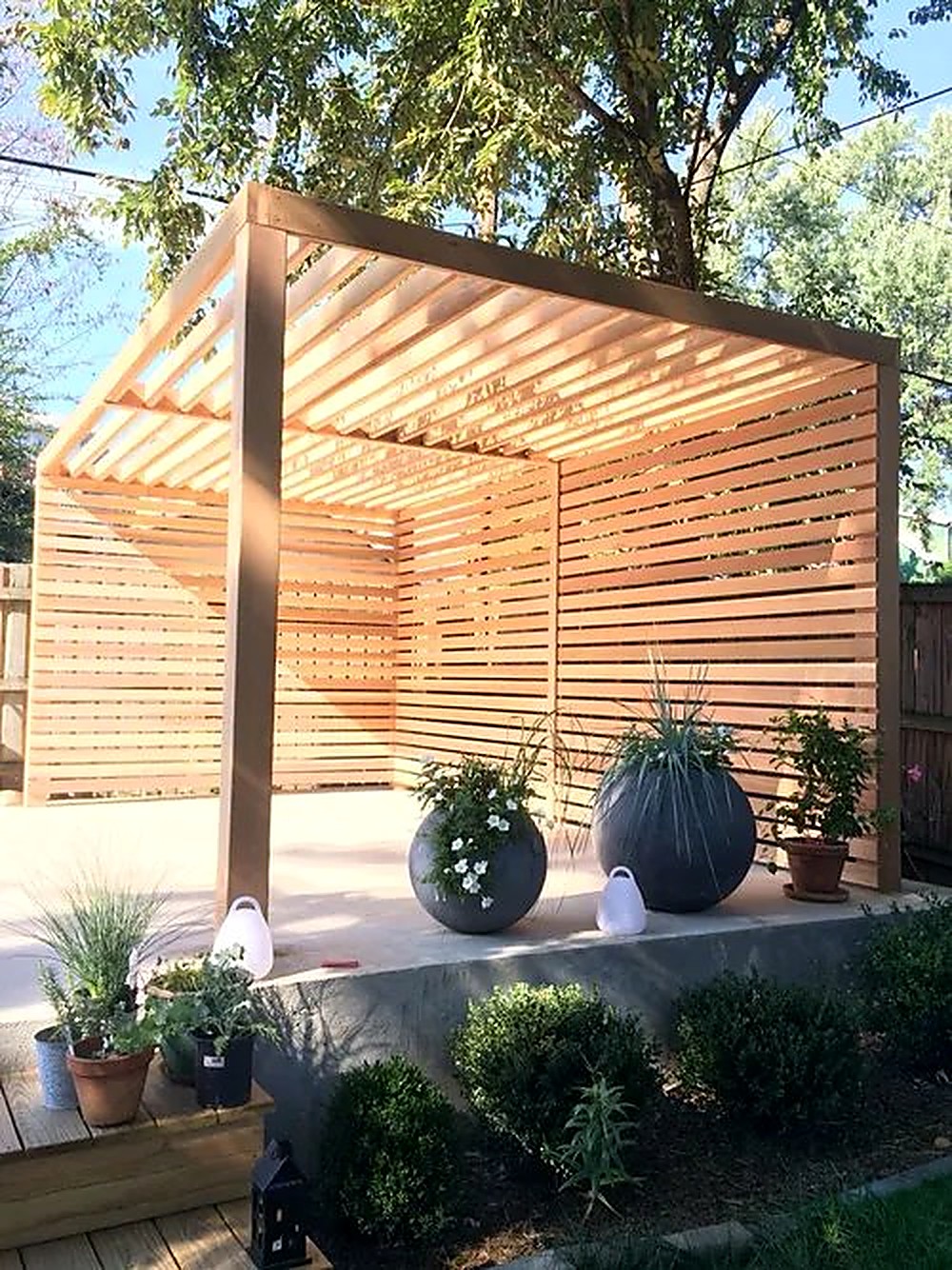 Western red cedar pergola with slatted privacy screening over a patio